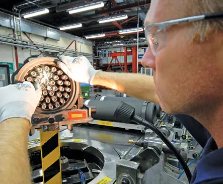 Man wearing safety glasses working on a machine
